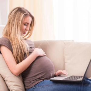 Pregnant Woman on the Couch Registering at Amazon Baby Registry