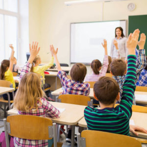 Class of Students Raising their Hands: Creating Classroom Culture with a Strong Classroom Management Plan