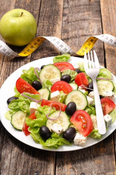 Healthy habits: salad, apple, water bottle, and weights