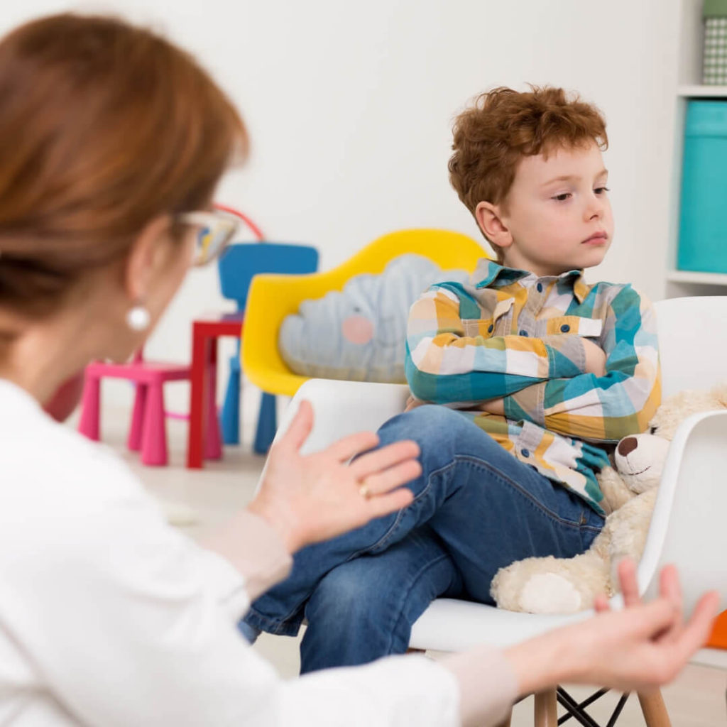 Teacher trying to calm an upset boy. 