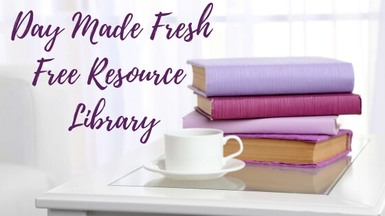 Stack of books and coffee cup on a table | Day Made Fresh Resource Library