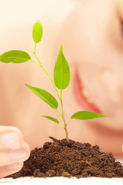 Young kid growing a plant