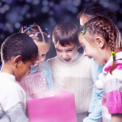 Group of 5 students looking at a gift from their teacher