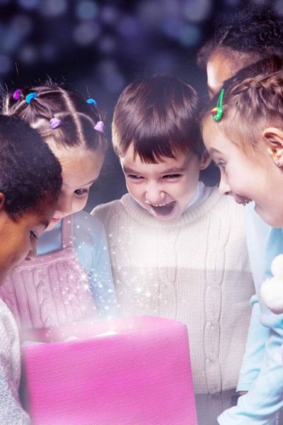 Group of 5 students looking at a gift from their teacher