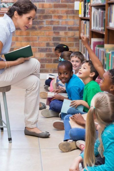 Teacher reading aloud growth mindset books to elementary students