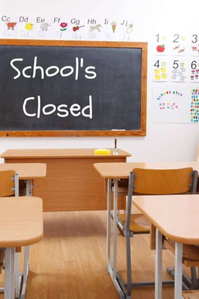 Empty Classroom with Board that says School's Closed