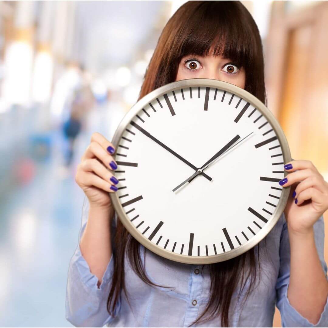 Overwhelmed teacher holding a clock