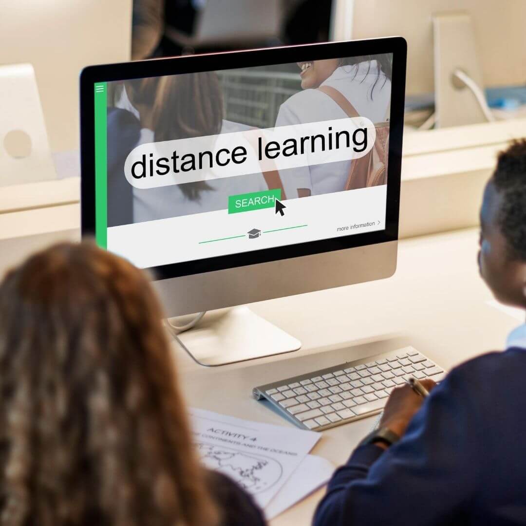 Two elementary students doing distance learning on a computer