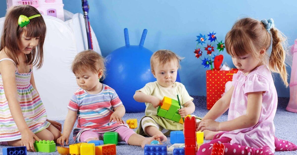 Two Babies and Two Toddlers Playing at Daycare