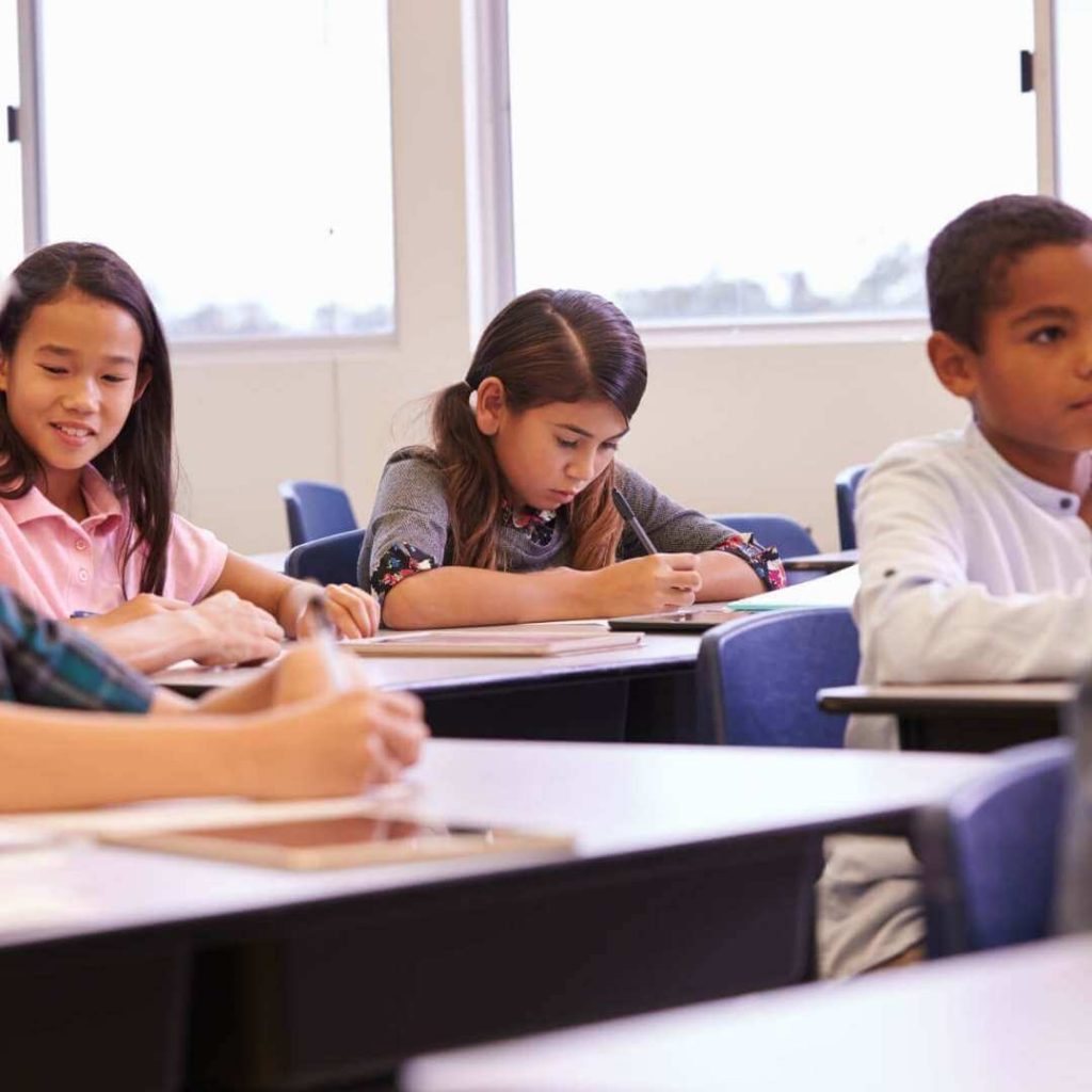 Elementary students working independently at their desks during transition time