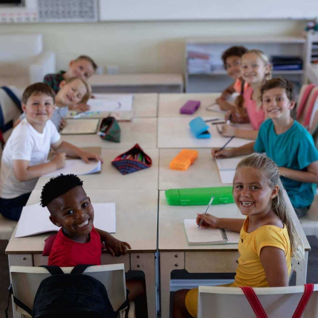 Eight elementary students using reusable student activities independently at their desk.